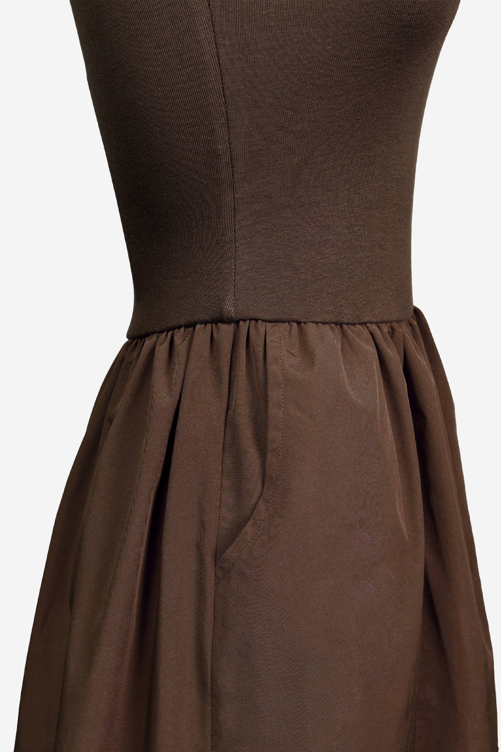Brown dress on a mannequin with a plain background