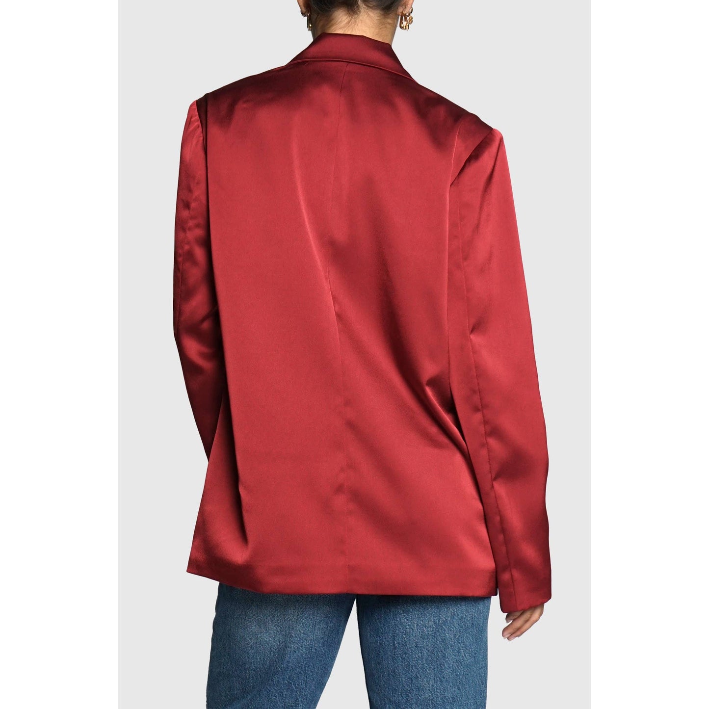Red satin jacket worn by a person on a white background