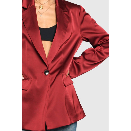 Red blazer worn by a person on a white background