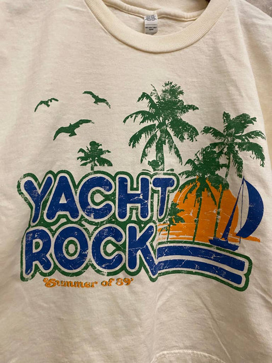 Beige t-shirt with 'Yacht Rock' graphic design featuring palm trees and a sailboat.
