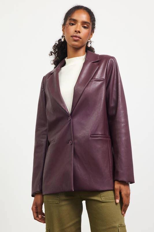 Woman wearing a purple leather jacket on a white background
