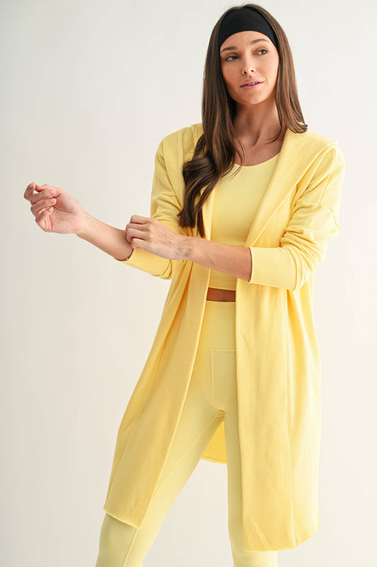 Woman wearing a yellow outfit on a plain background