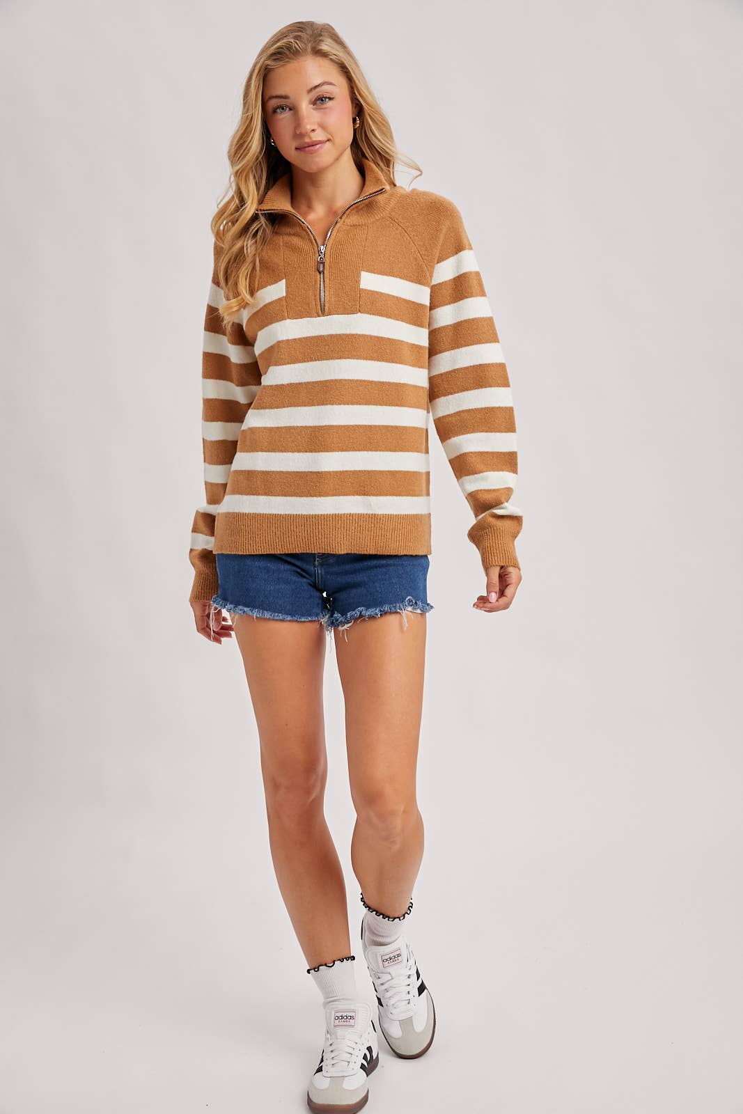 Woman wearing a striped sweater with a white background