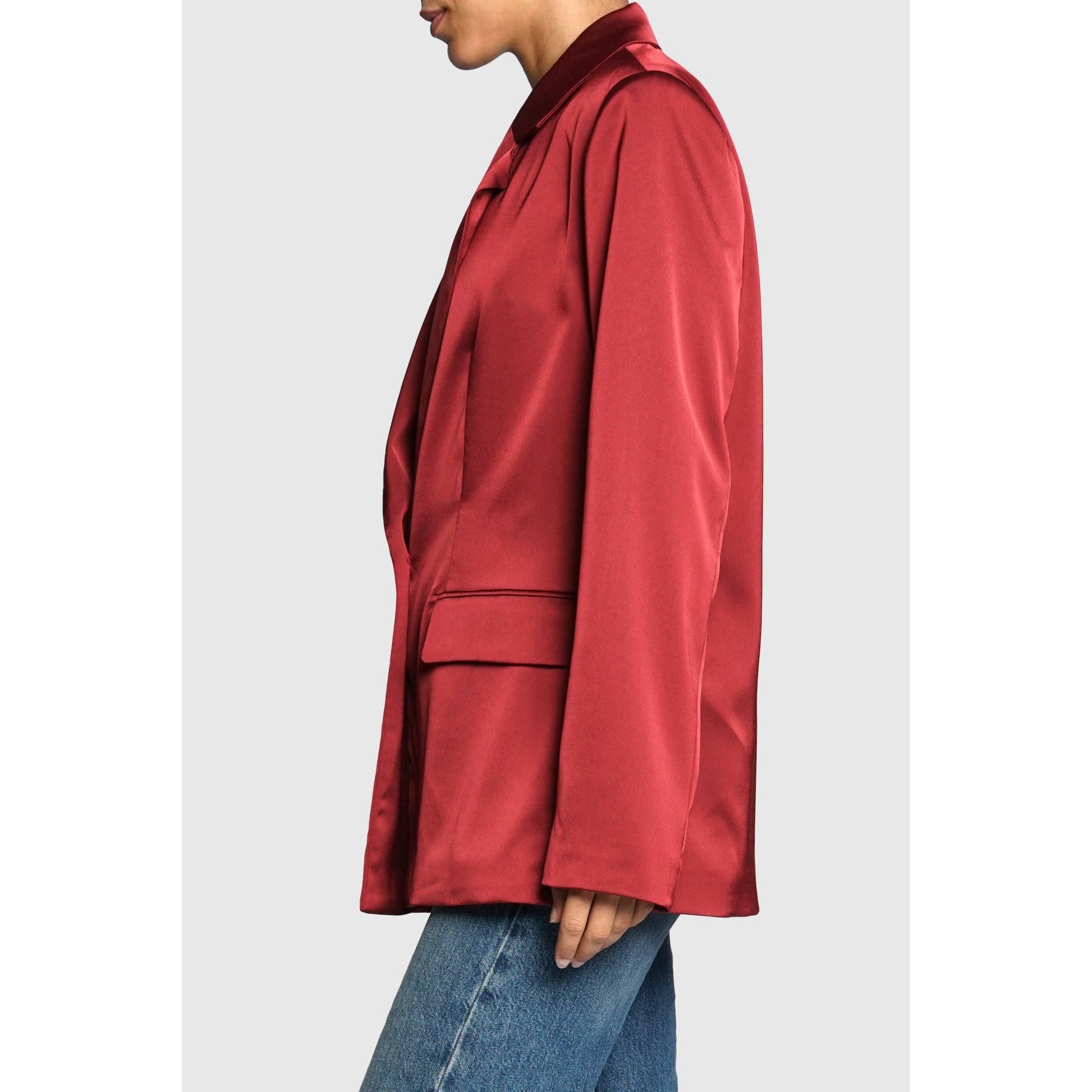 Red satin shirt worn by a person on a light gray background