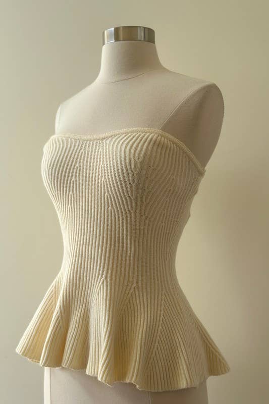 Beige ribbed top on a mannequin against a plain background