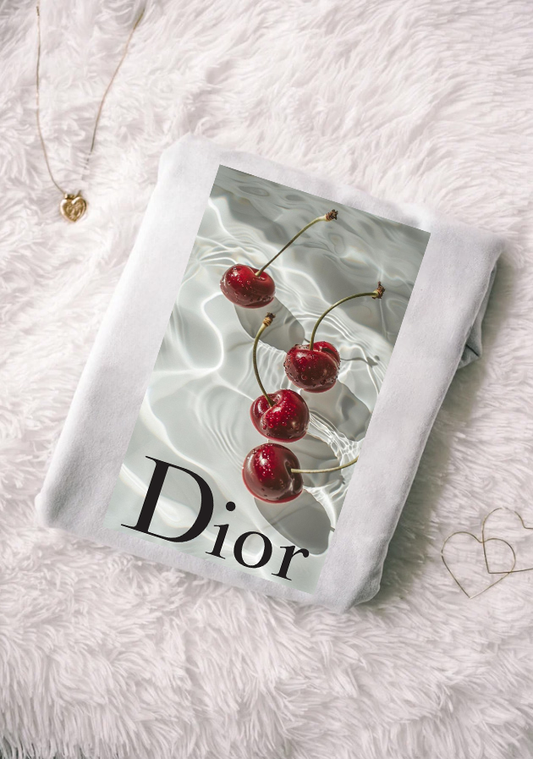 Dior product with cherries on a textured surface