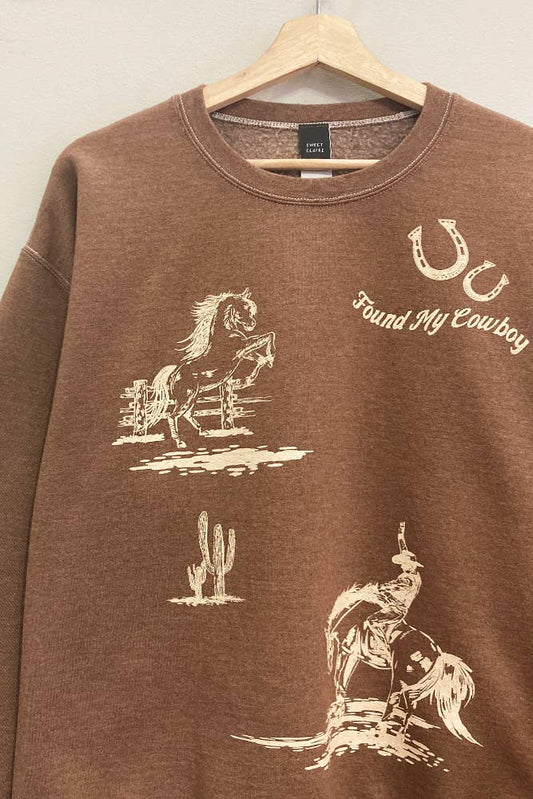 Brown sweatshirt with white graphic designs on a hanger against a light background