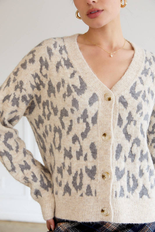 Leopard print cardigan worn by a person on a plain background