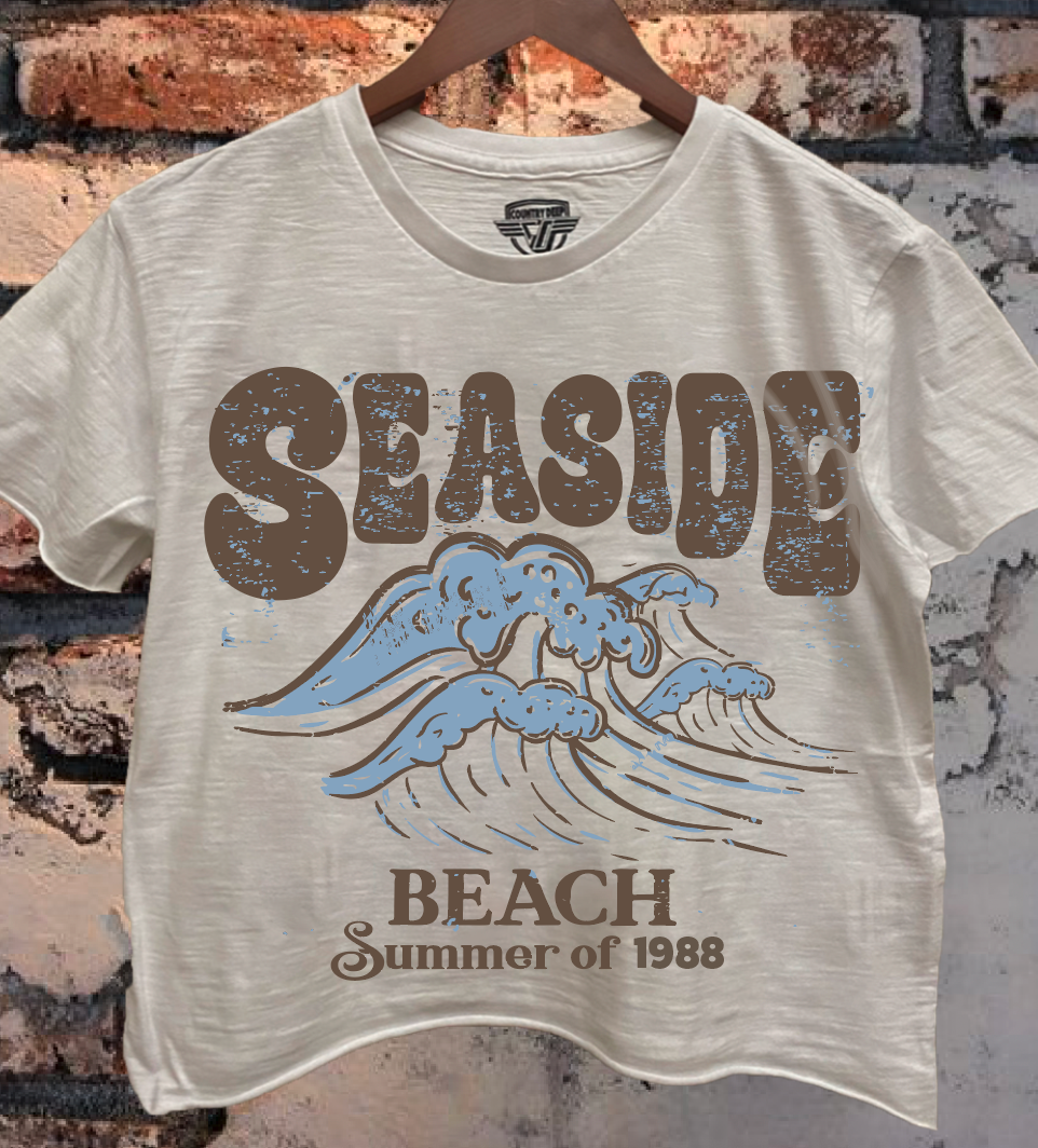 Beige t-shirt with 'Seaside Beach Summer of 1988' design on a brick wall background