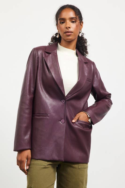 Woman wearing a purple leather jacket on a white background